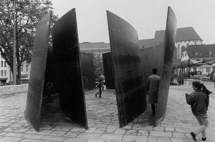 Four steel conical slab sculptures by Richard Serra titled Intersection, dated 1992.